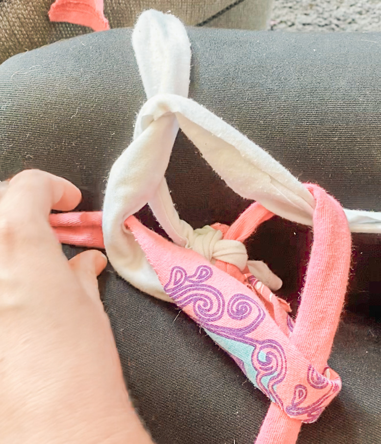 Lottie demonstrates a basic crown knot before it's pulled tight